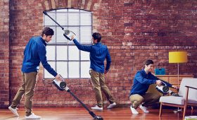 Man vacuums urban apartment